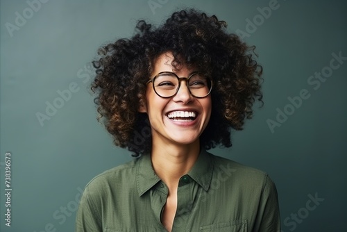 Portrait of a beautiful young african american woman laughing and wearing glasses