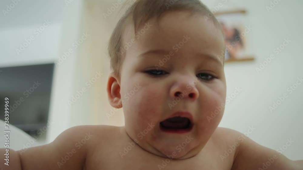 Baby boy reaching for and looking at the camera Baby boy reaching for and looking at the camera