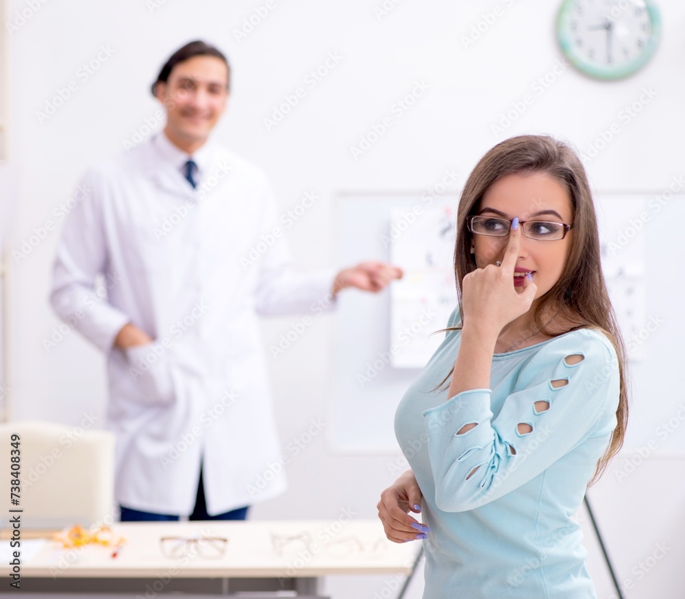 Fototapeta premium Young woman visiting male doctor oculist