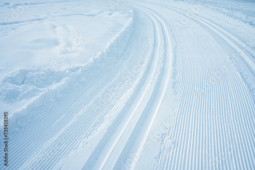 Cross-country skiing track on snowy ground, made with a track machine.