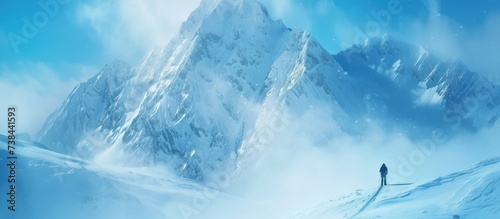 A lone individual embraces winter sports amidst a stunning mountain backdrop.