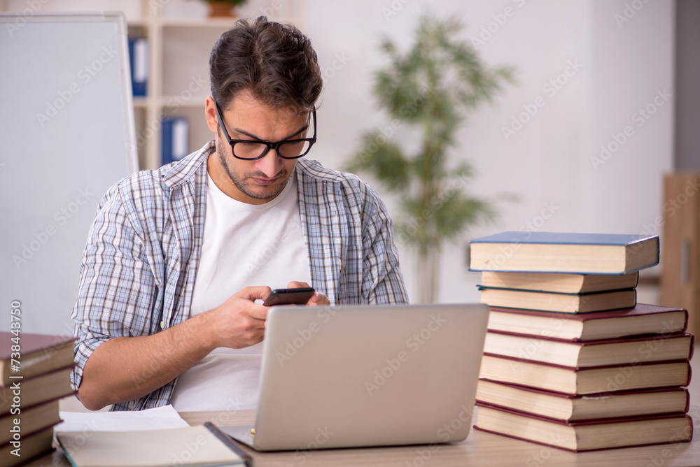 Young male student preparing for exams in the classroom Young male student preparing for exams in the classroom