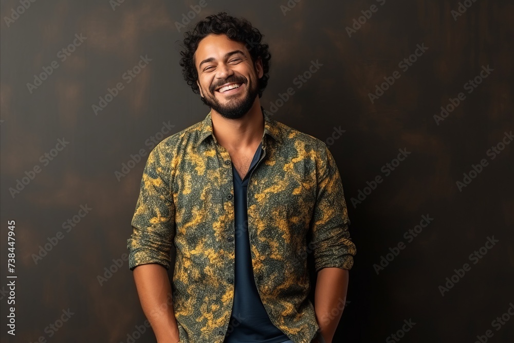 Portrait of a handsome latin man smiling against a dark background Portrait of a handsome latin man smiling against a dark background