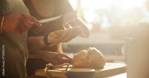 Woman, hands and lesbian couple with bread, spread or butter for meal, snack or wheat in kitchen at home. Closeup of female person, LGBTQ or gay people making food, breakfast or morning loaf on table photo