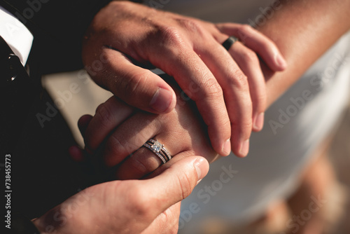 A wedding ring is a finger ring typically worn on the base of the left ring finger, indicates that its wearer is married, usually forged from metal, traditionally gold or another precious metal photo