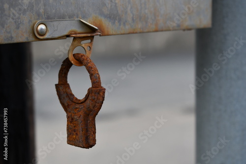 Fotografija Rusted tamper proof lock on electrical control panel.