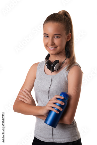 Young sporty young girl in sportswear with headset and water bottle over white background