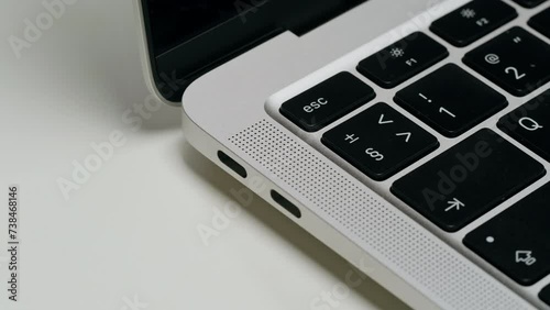 Wallpaper Mural Opening grey laptop on whte background close-up. Charging connection to computer. Phone charging port. USB wire for devices Torontodigital.ca