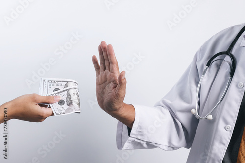 Doctor's hands refusing money from bribing. Bribery and anti corruption concept photo