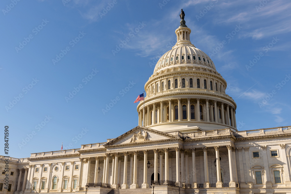 The United States Capitol building with the American flag flying atop its flagpole, Washington DC - obrazy, fototapety, plakaty 