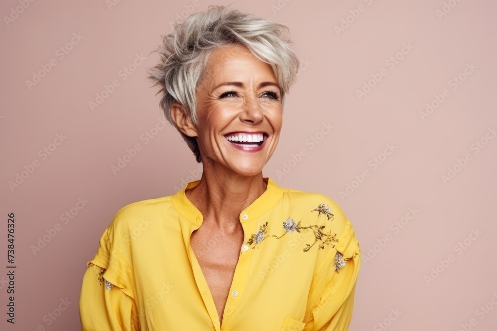 Portrait of a happy senior woman smiling at the camera over pink background Portrait of a happy senior woman smiling at the camera over pink background
