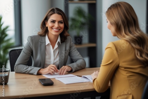 Smiling Female Manager Interviewing an Applicant In Office