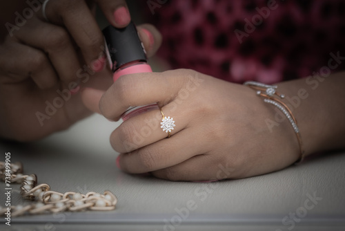 Girl putting nail paint photo