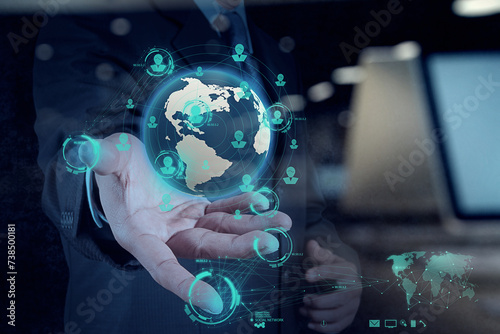 businessman hand working with new modern computer show the earth social network structure photo