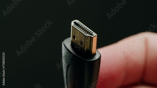 Charging connection to laptop on white table close-up . Phone charging port. USB wire for devices