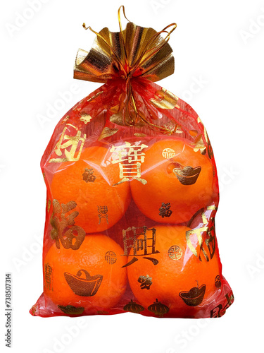 Oranges in a Chinese cloth bag isolated on white background. Oranges are auspicious fruits according to Chinese beliefs because their skin color is like gold. And in Chinese it also means happiness.