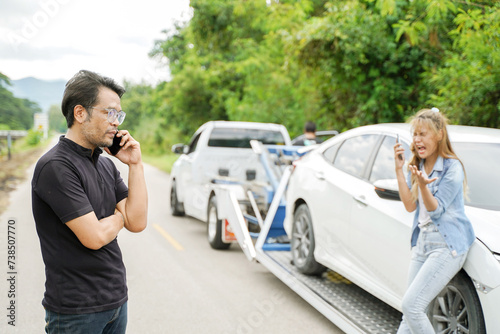 Closeup driver in Car Accident using mobile phone with damaged car truck slides on countryside and sun flare background.