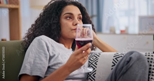 Depression, wine and drunk with bored woman on sofa in living room of home to relax or drink. Sad, frustrated or unhappy and young alcoholic person drinking in apartment with mental health problems photo