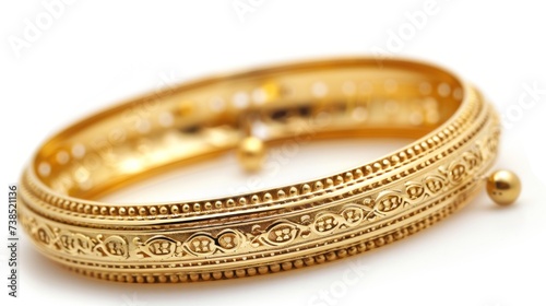 Big gold bangle bracelet with beautiful pattern isolated on white background.