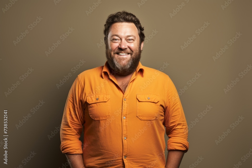 Happy man with beard and mustache in orange shirt on grey background. Happy man with beard and mustache in orange shirt on grey background.