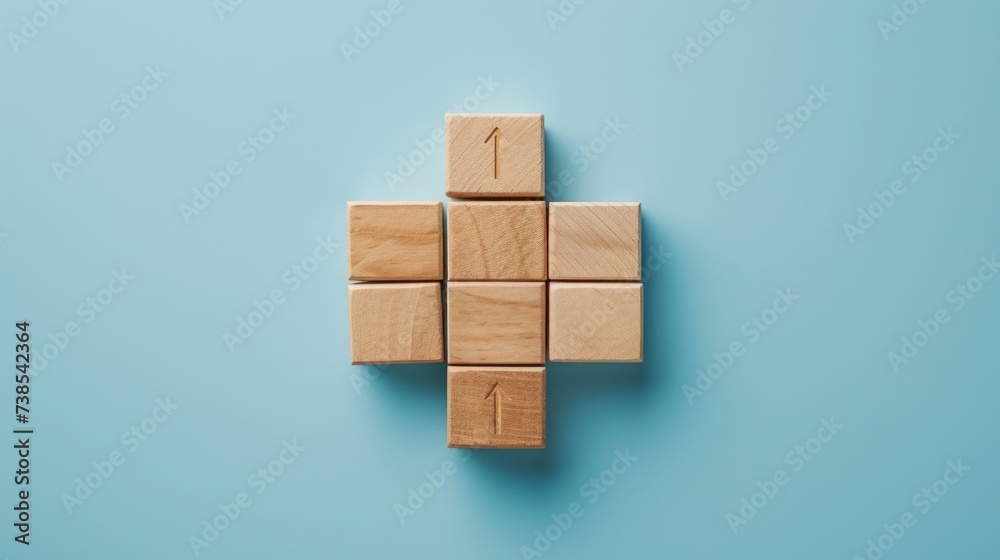 Obraz premium Wooden blocks with an arrow at the bottom, featuring minimalist grids in sky-blue hues, embodying minimalist precision, socially engaged work, and the use of common materials.