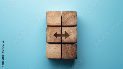 Wooden blocks with an arrow at the bottom, featuring minimalist grids in sky-blue hues, embodying minimalist precision, socially engaged work, and the use of common materials. photo