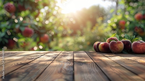 Empty rustic old wooden board table copy space with peach trees or an orchard in the background. Some ripe fruits are on the desk. Product display template.