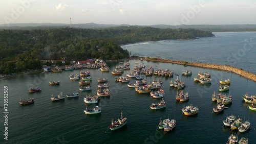 Many traditional colorful fishing boats in the tropical bay in Sri Lanka
