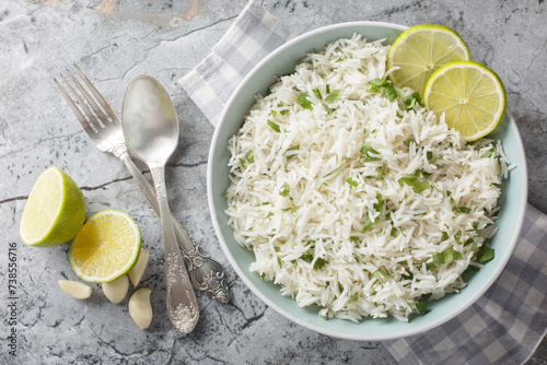 Obraz na płótnie Organic cilantro lime rice with garlic and zest close-up in a bowl on the table