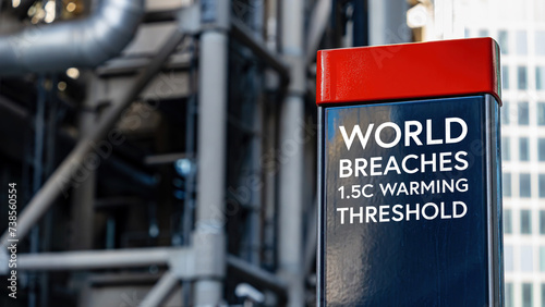 World breaches 1.5C warming threshold on a sign in front of an Industrial building 