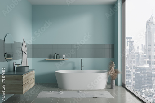 Elegant blue home bathroom interior with sink  bathtub and panoramic window