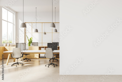 Modern white coworking office interior with blank wall