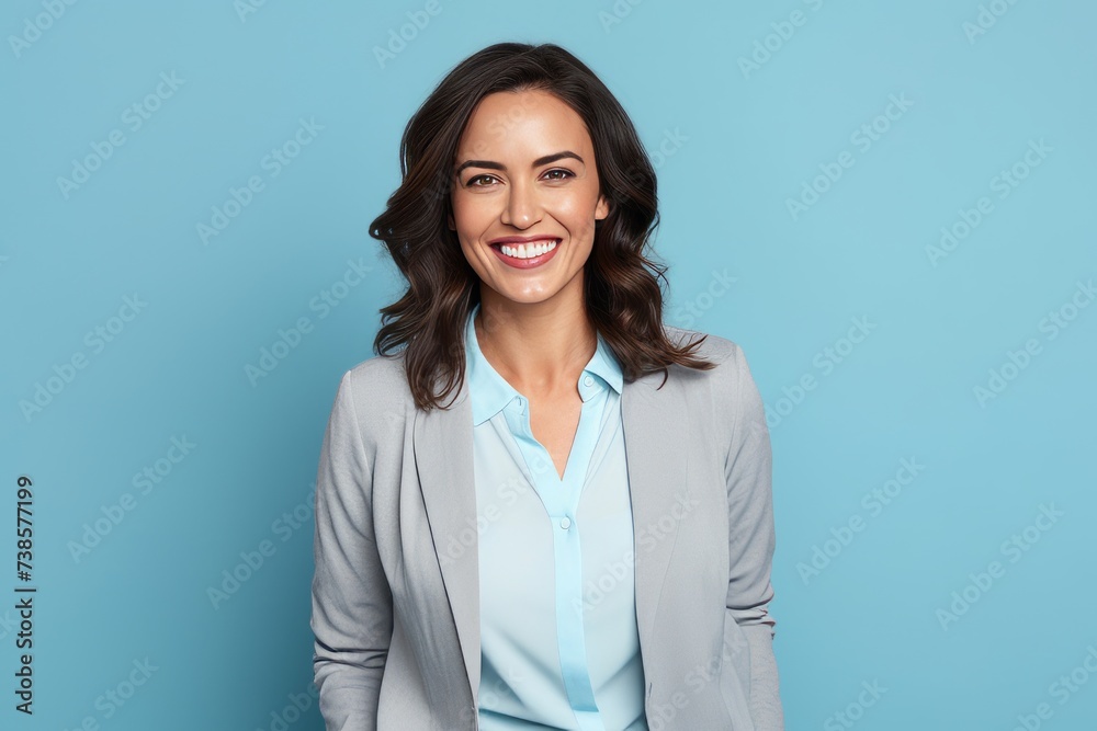 Portrait of happy smiling businesswoman in suit, over blue background Portrait of happy smiling businesswoman in suit, over blue background