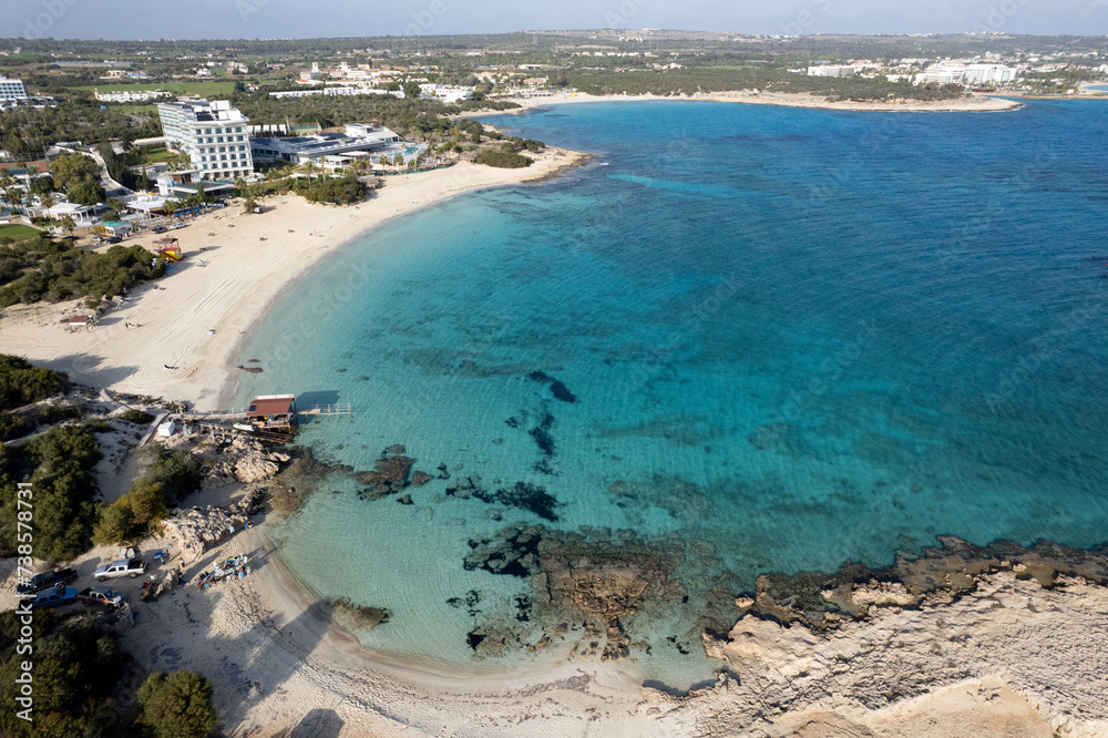 Drone aerial top view of empty tropical sandy beach in winter. Makronisos bay beach Ayia Napa Cyprus