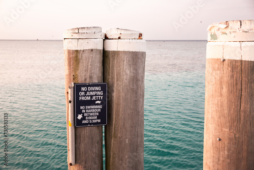 Heron Island jetty with no diving or jumping from jetty sign photo
