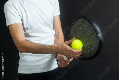 Paddle tennis player ready for serve on gray background © Angelov