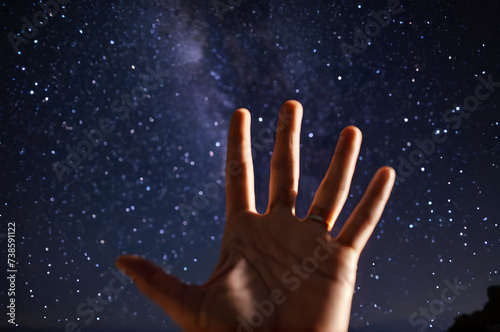 The palm of a man against the background of the starry sky.