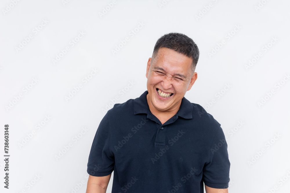 Portrait of a cheerful middle-aged Asian man laughing heartily, with a white background providing copy space. Portrait of a cheerful middle-aged Asian man laughing heartily, with a white background providing copy space.