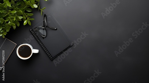 High angle view of businessman desk with organizer, pen, glasses and green plant. Top view of office supplies on blackboard background with copy space