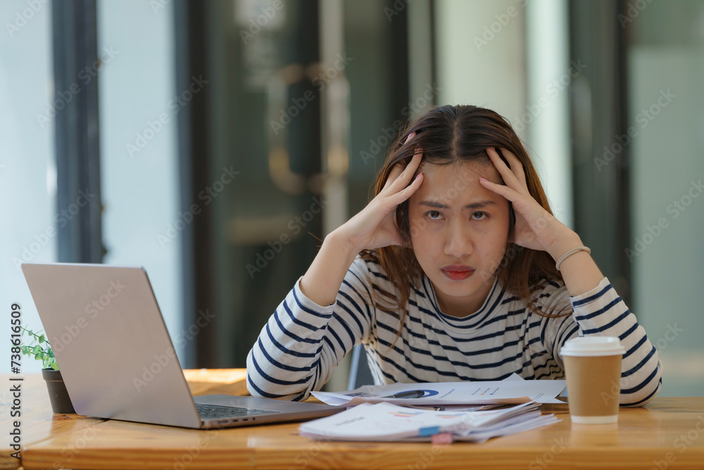Tired, exhausted Asian businesswoman with a laptop, problems with the project, depression, laziness in an office. Tired, exhausted Asian businesswoman with a laptop, problems with the project, depression, laziness in an office.