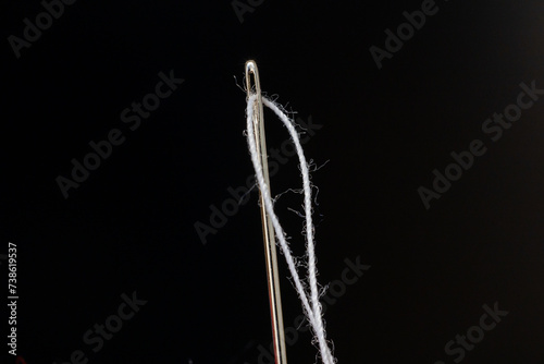 thread threaded into a sewing needle