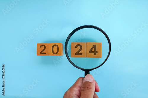 Magnifying glass and targets 2025. Concept of new year 2025, beginning of success, challenge or career path, change, planning, goals, challenges and new year resolutions.