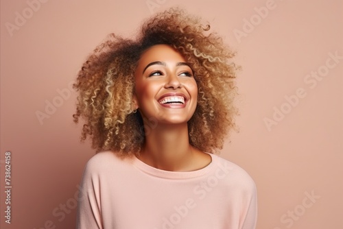 Portrait of beautiful young african american woman with curly hair © Loli