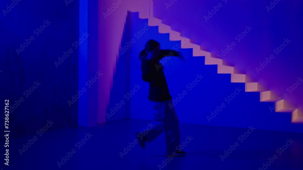 Young Hip-Hop Female Dancer Rehearsing Alone In Studio With Art Blue And Pink Lights, Full-Length
