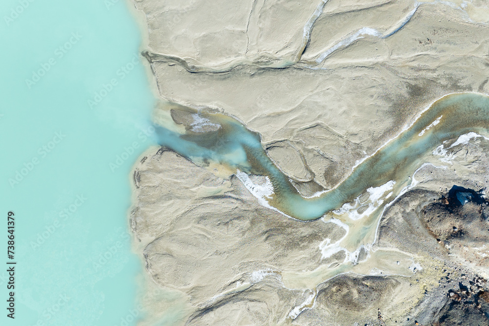 Drone view of the azure lake in the glacier valley. View of the moraines. Landscape from the air. River on a moraine. Landscape from drone. Alberta, Canada.