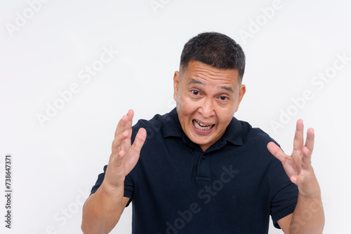 An expressive middle aged man looks frustrated and upset while explaining or arguing, isolated on a white background.