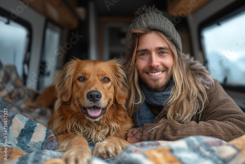 Smiling couple with dog lying in motor home.