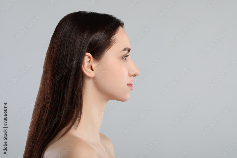 Beautiful young woman with healthy skin on light grey background. Space for text Beautiful young woman with healthy skin on light grey background. Space for text