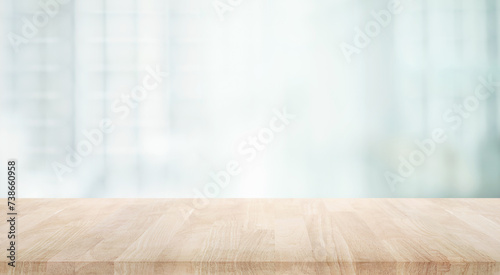 Selective focus.Top of wood table with window glass and cityscape background