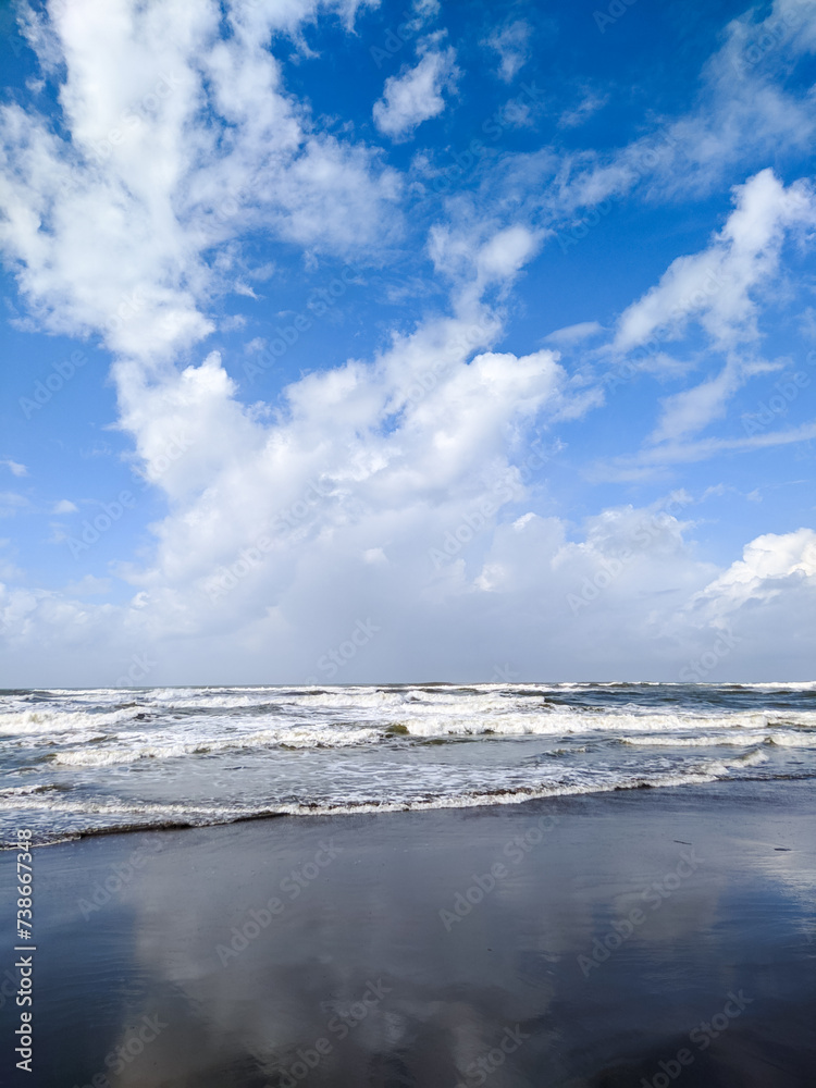 Parangtritis beach. The expanse of beach waves with bright white clouds makes the beach beautiful